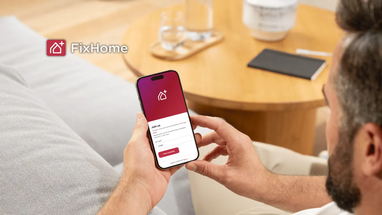 Man with phone using FixHomePlus App 