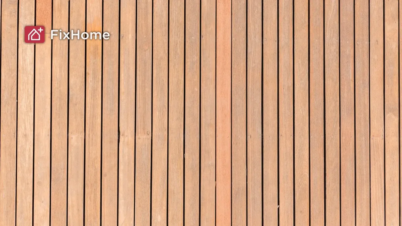Wooden deck planks arranged in vertical lines, showing a light brown color 