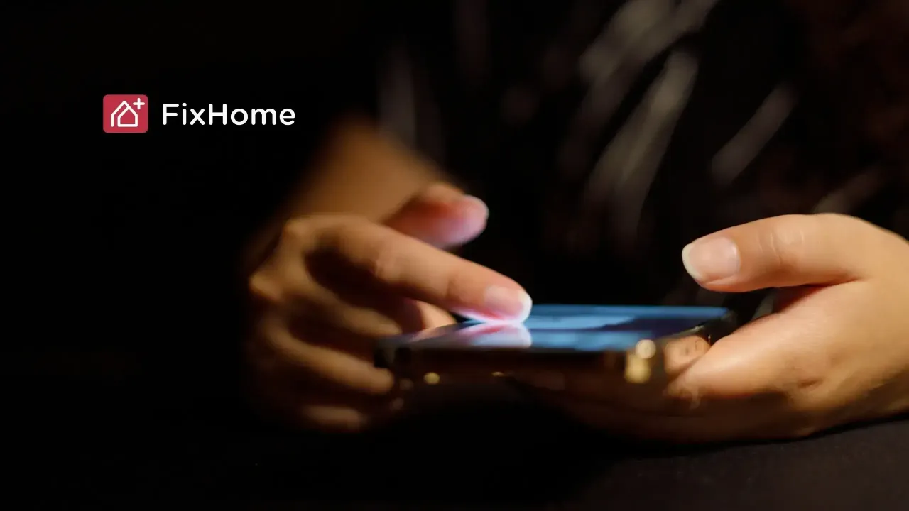 Female hand with phone in the dark space