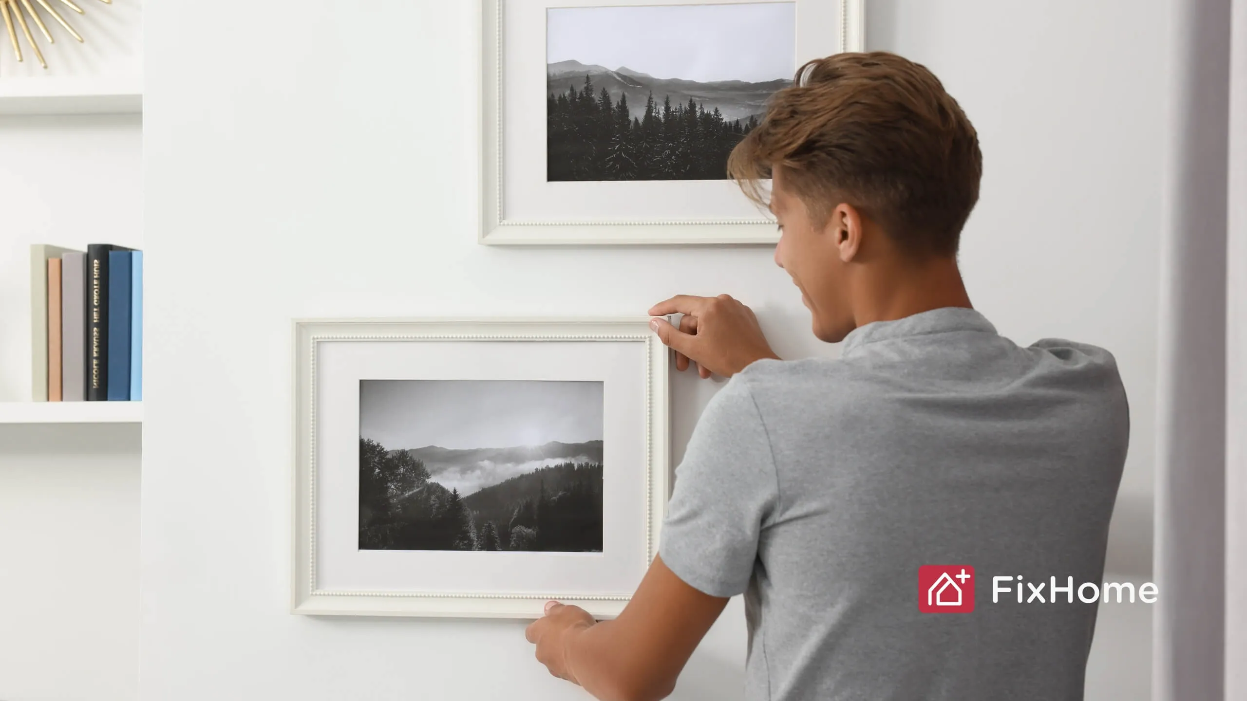 Man hang up the art on the wall