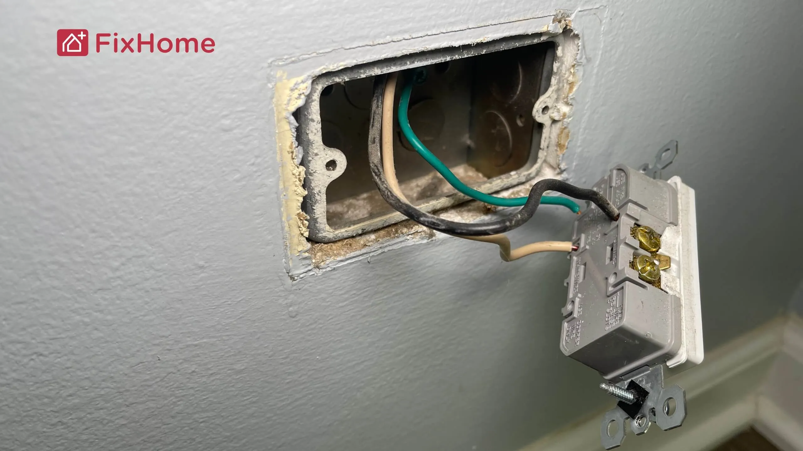 Old wall outlet with exposed wires