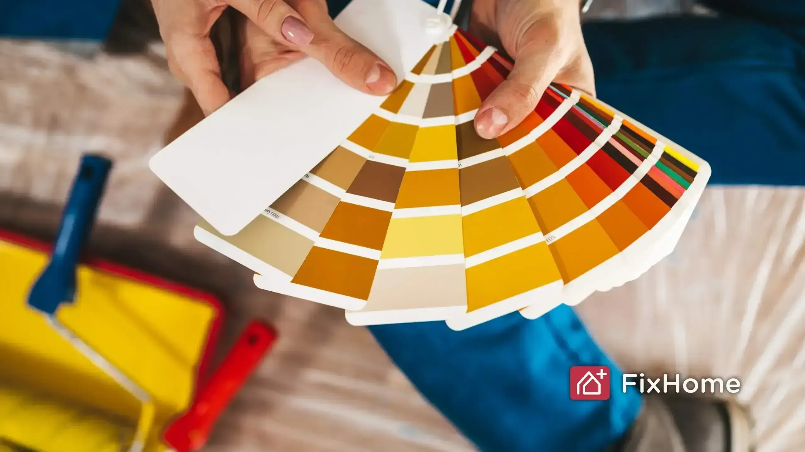 Paint swatches, roller tray, and drop cloth for painting