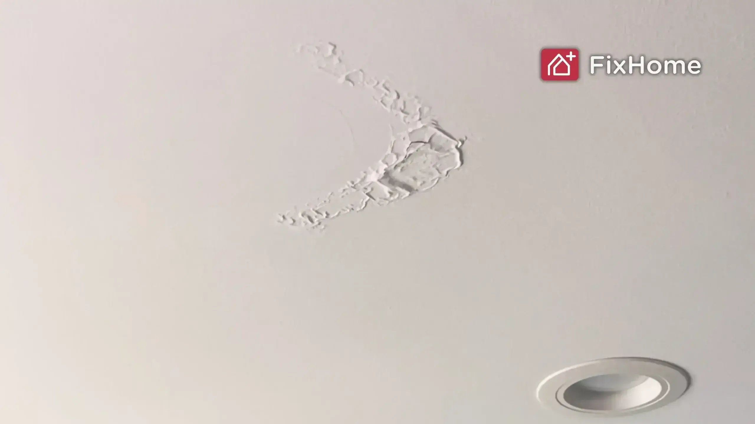Ceiling with peeling plaster, indicating potential water damage