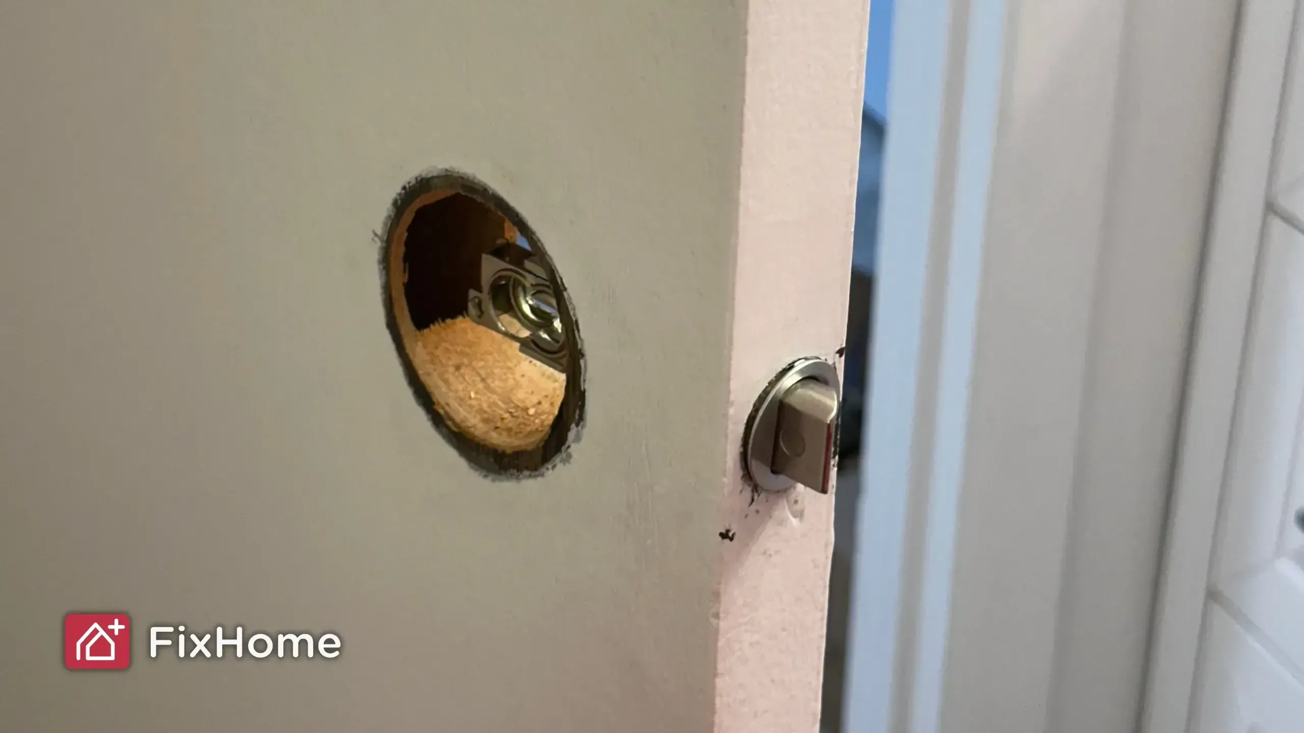 A door with a visible latch mechanism and a circular cutout for a doorknob