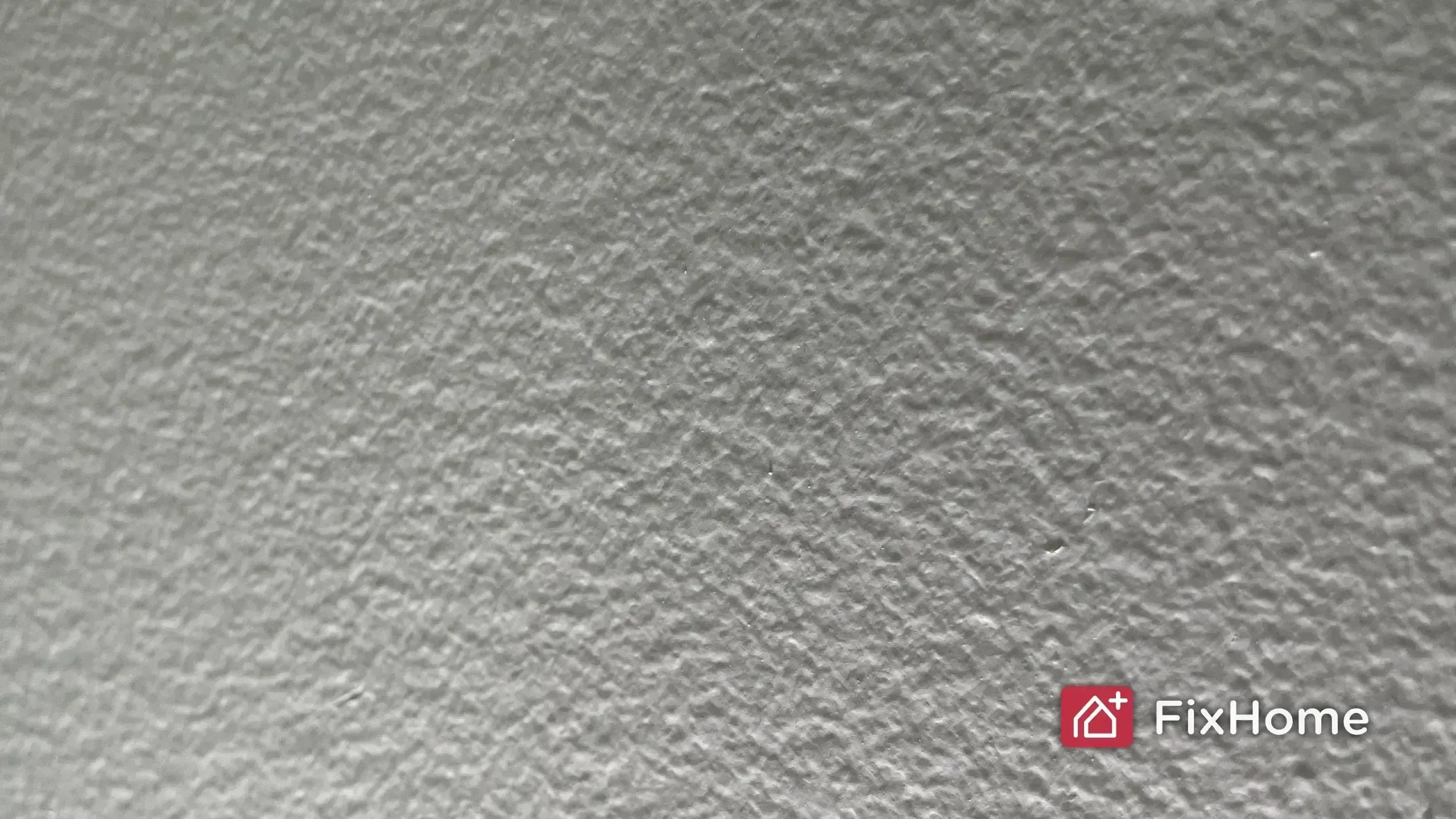 Textured wall with FixHome logo in the corner