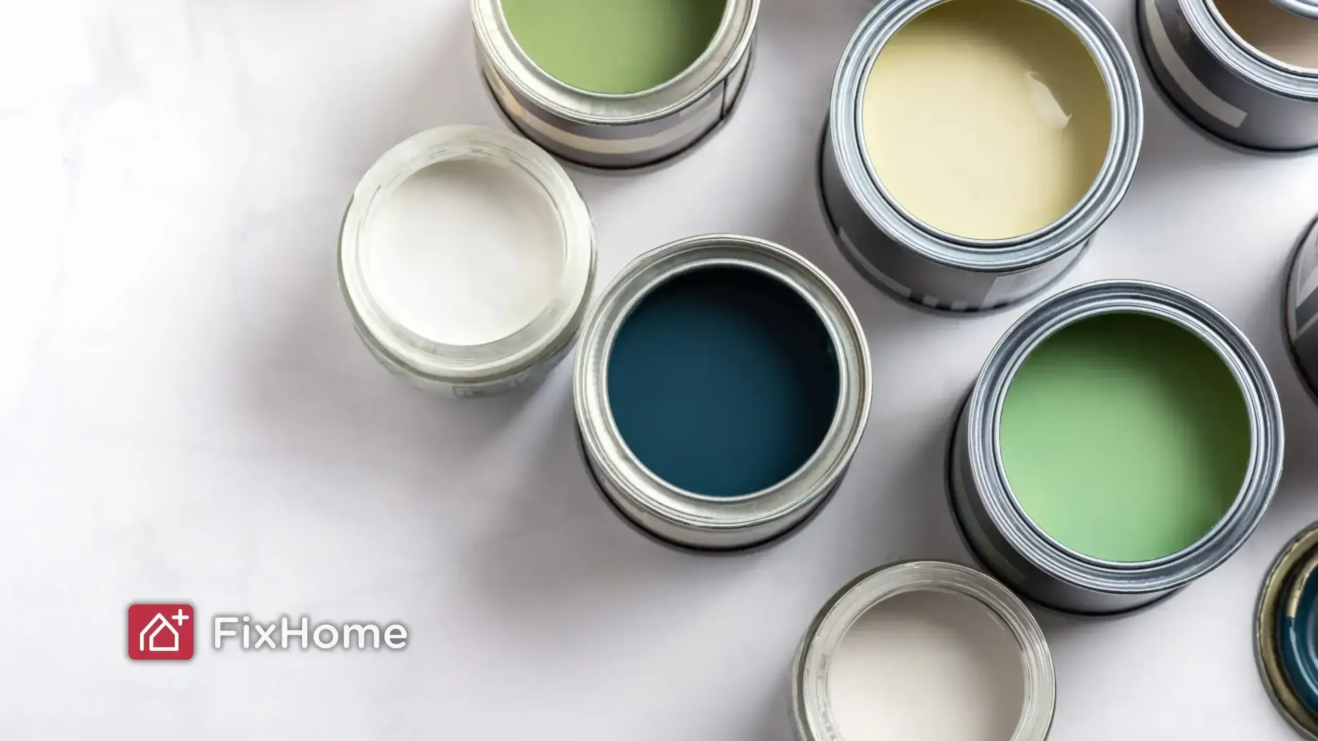 Open paint cans displaying various colors