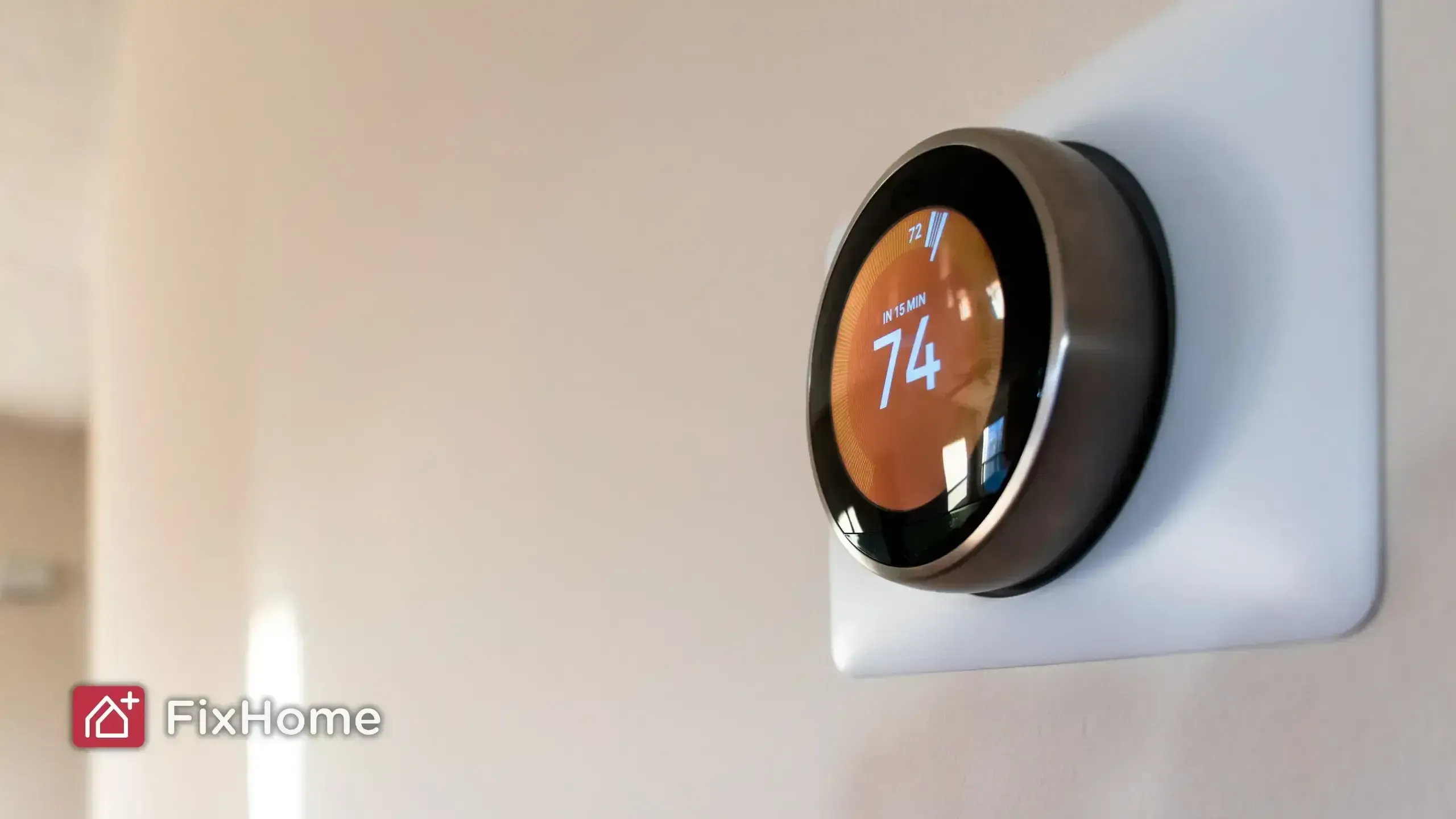 Smart thermostat mounted on a beige wall, showing a temperature setting of 74 degrees with a scheduled adjustment in 15 minutes