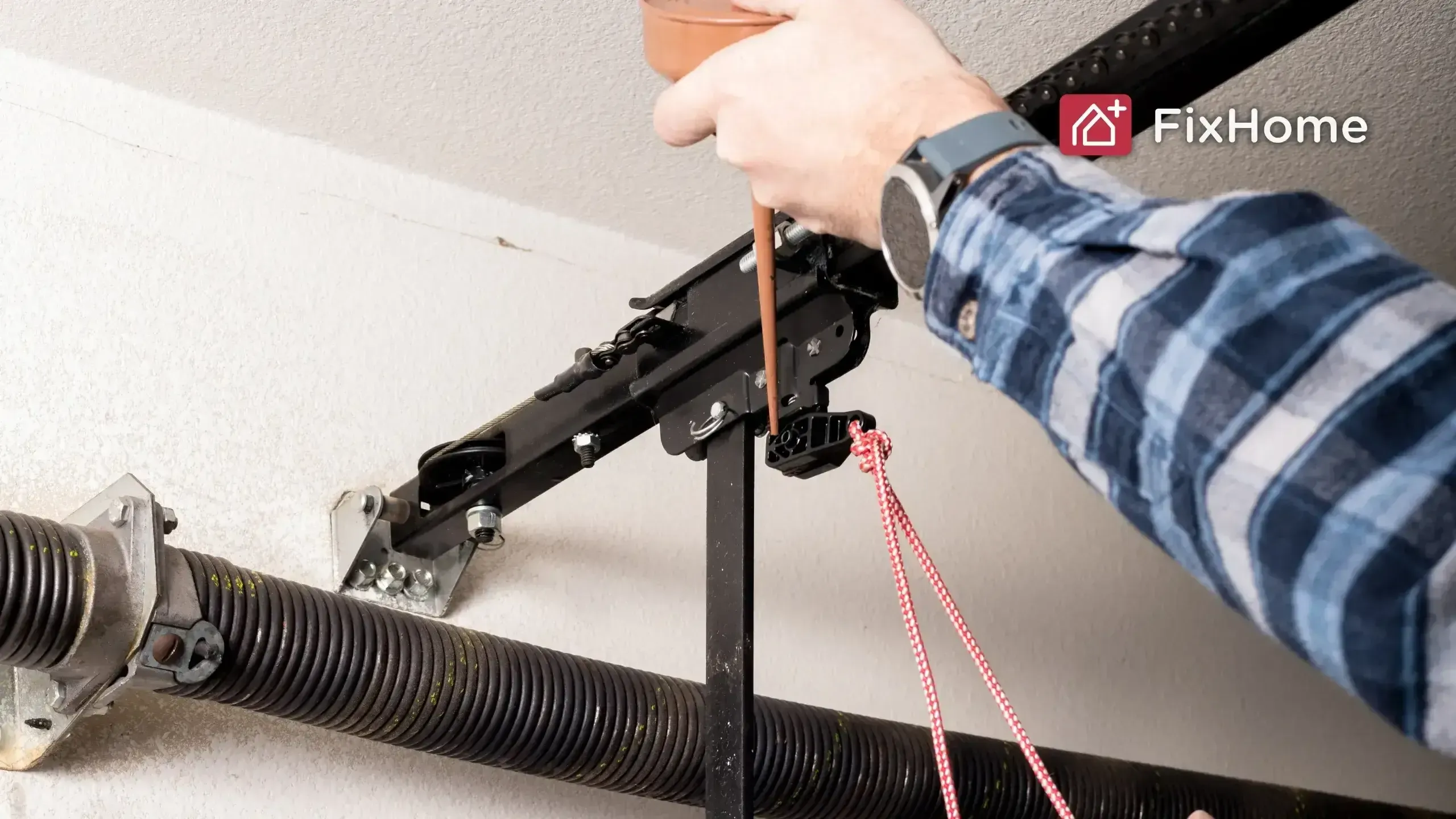 A handyman uses a funnel to pour lubricant onto a garage door opener mechanism.