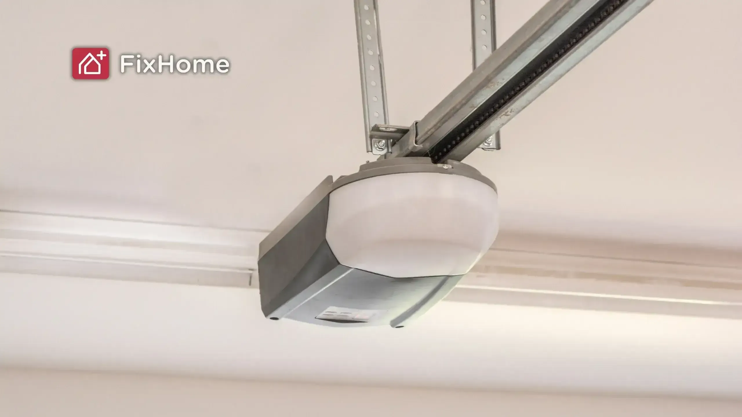 A garage door opener mounted on the ceiling, with a light and metal track.