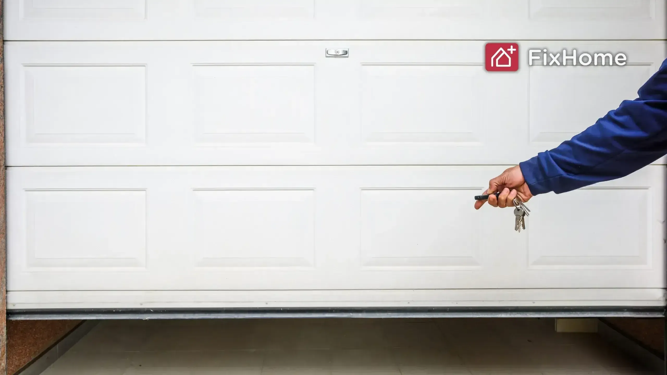 A person holding keys and a remote near a white garage door.