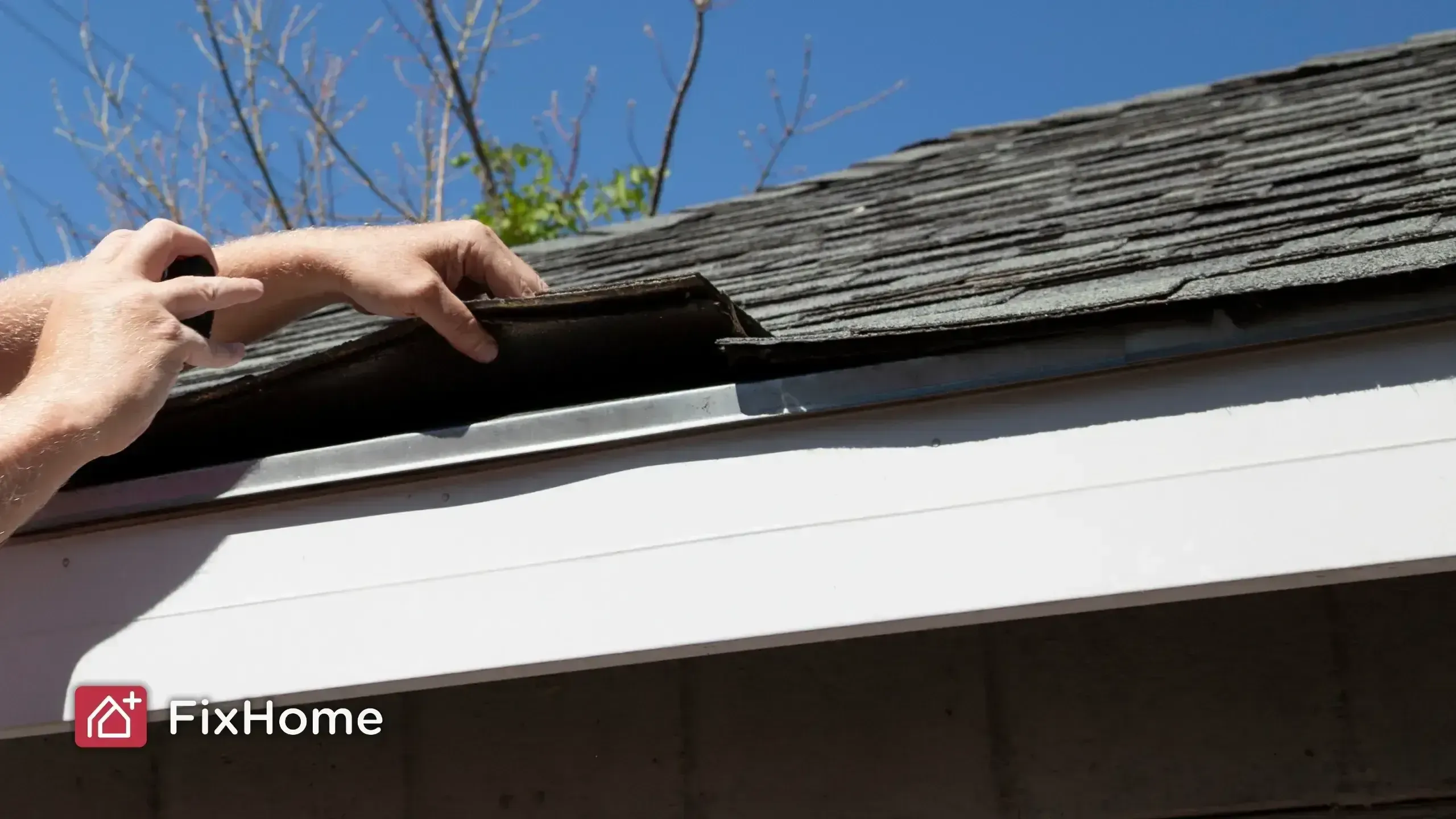 Home inspector adjusting roofing material near the edge of a roof
