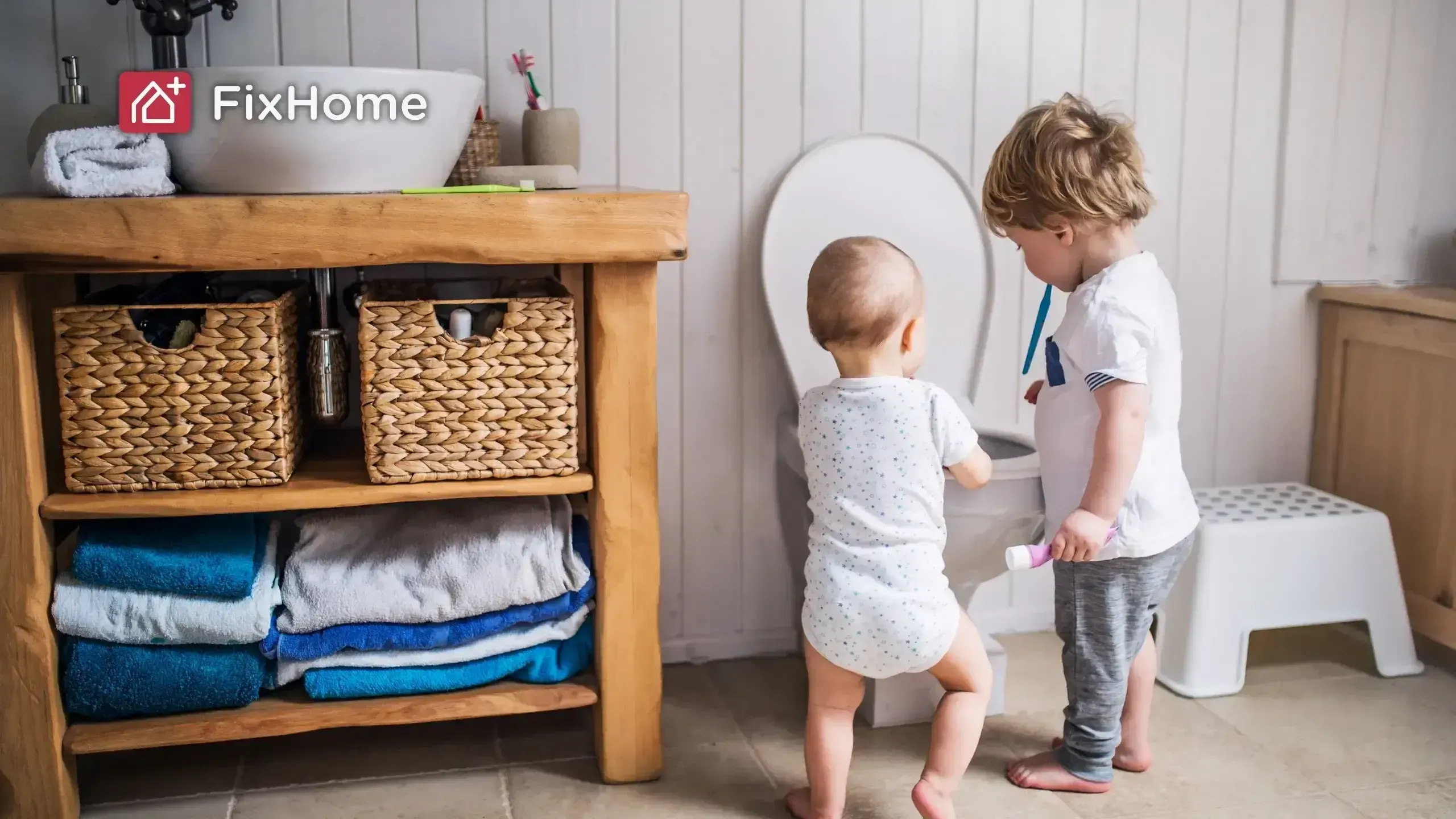 2 Babies close to toilet try to brush their teeth