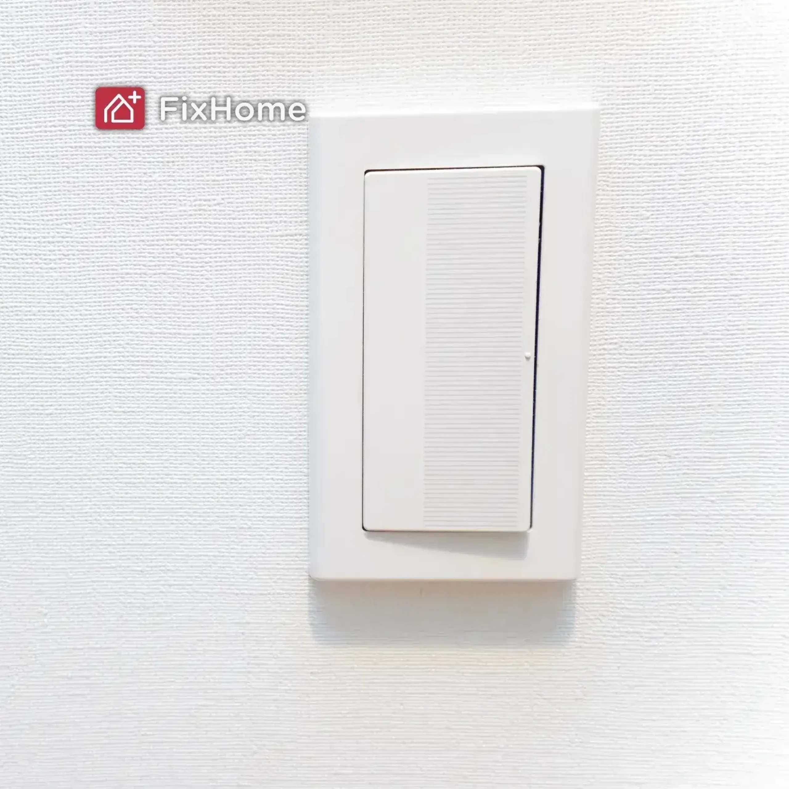 Dimmer switch on the textured wall