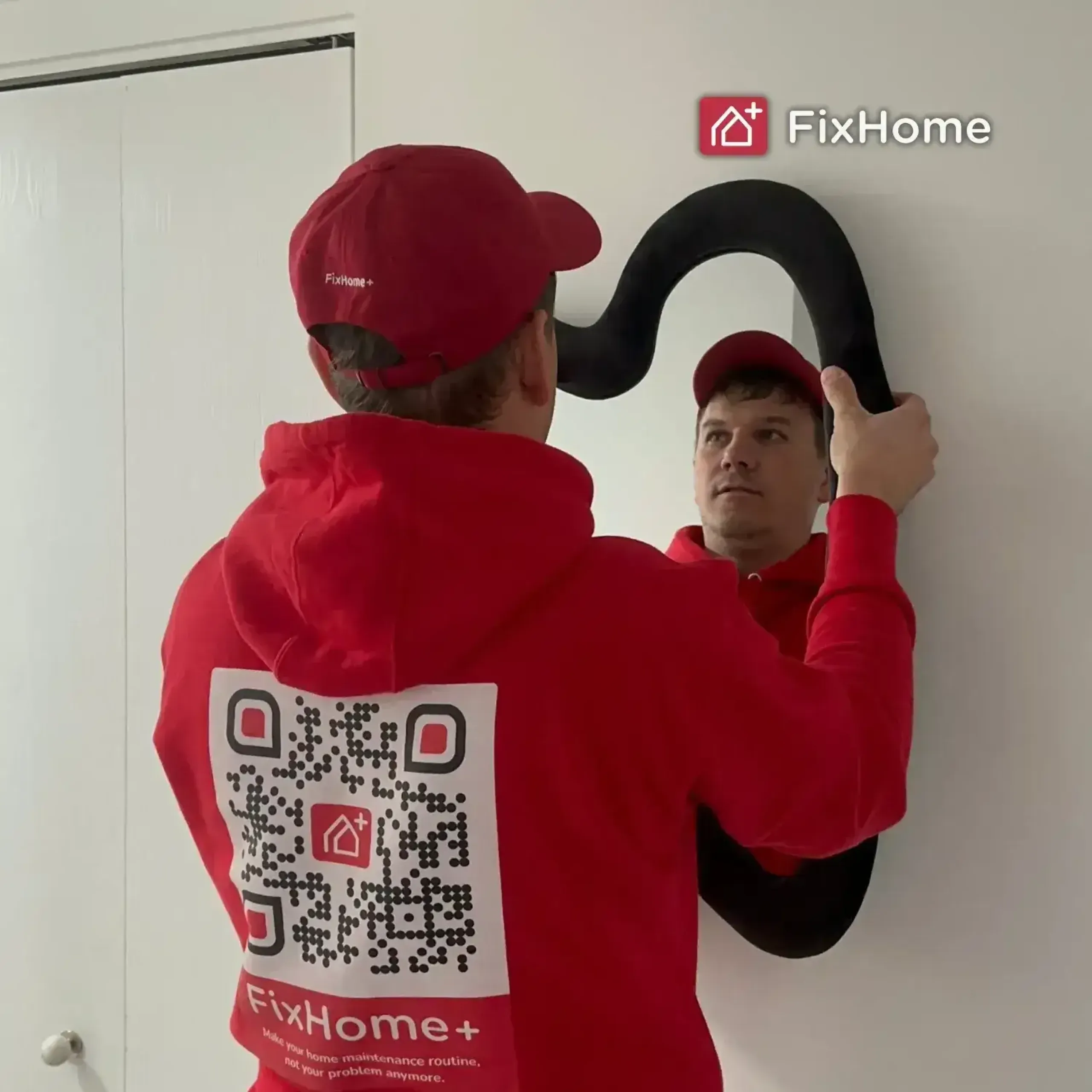 Handyman hanging a new mirror