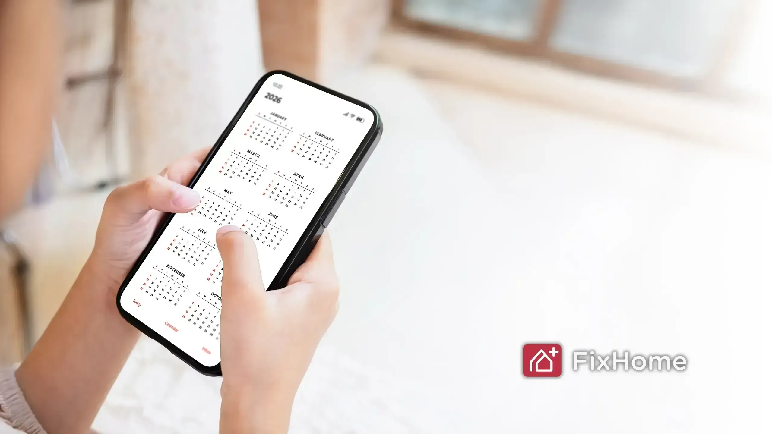 Female hand with phone with calendar app on it