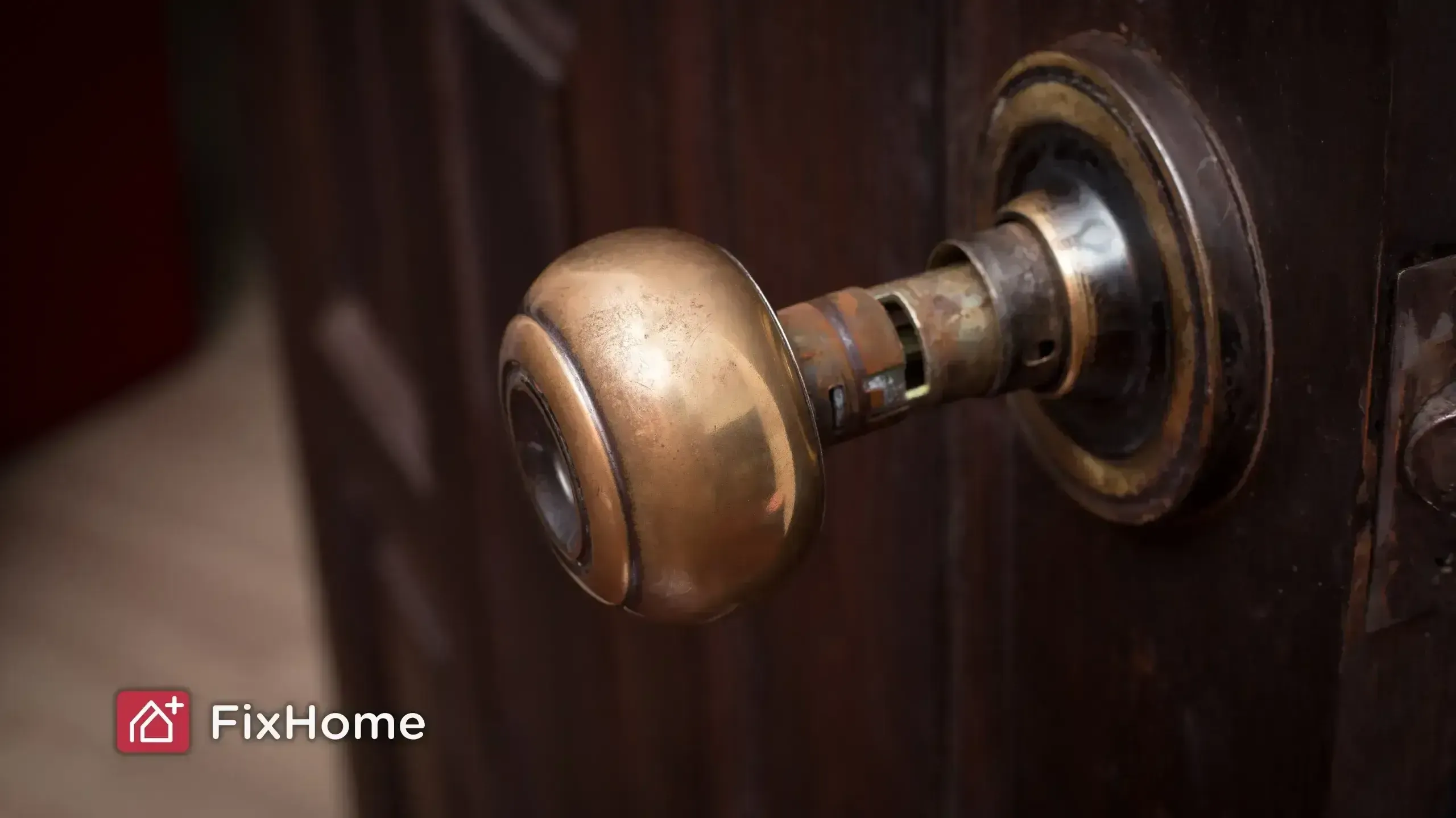Close up of broken doorknob on wooden door