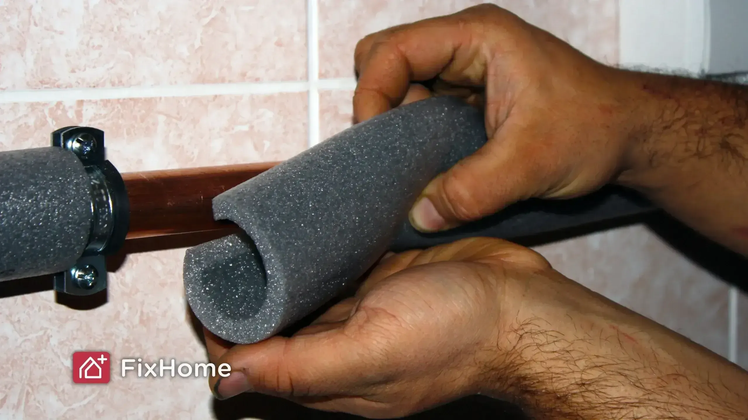 Worker hands make foam insulation for pipes