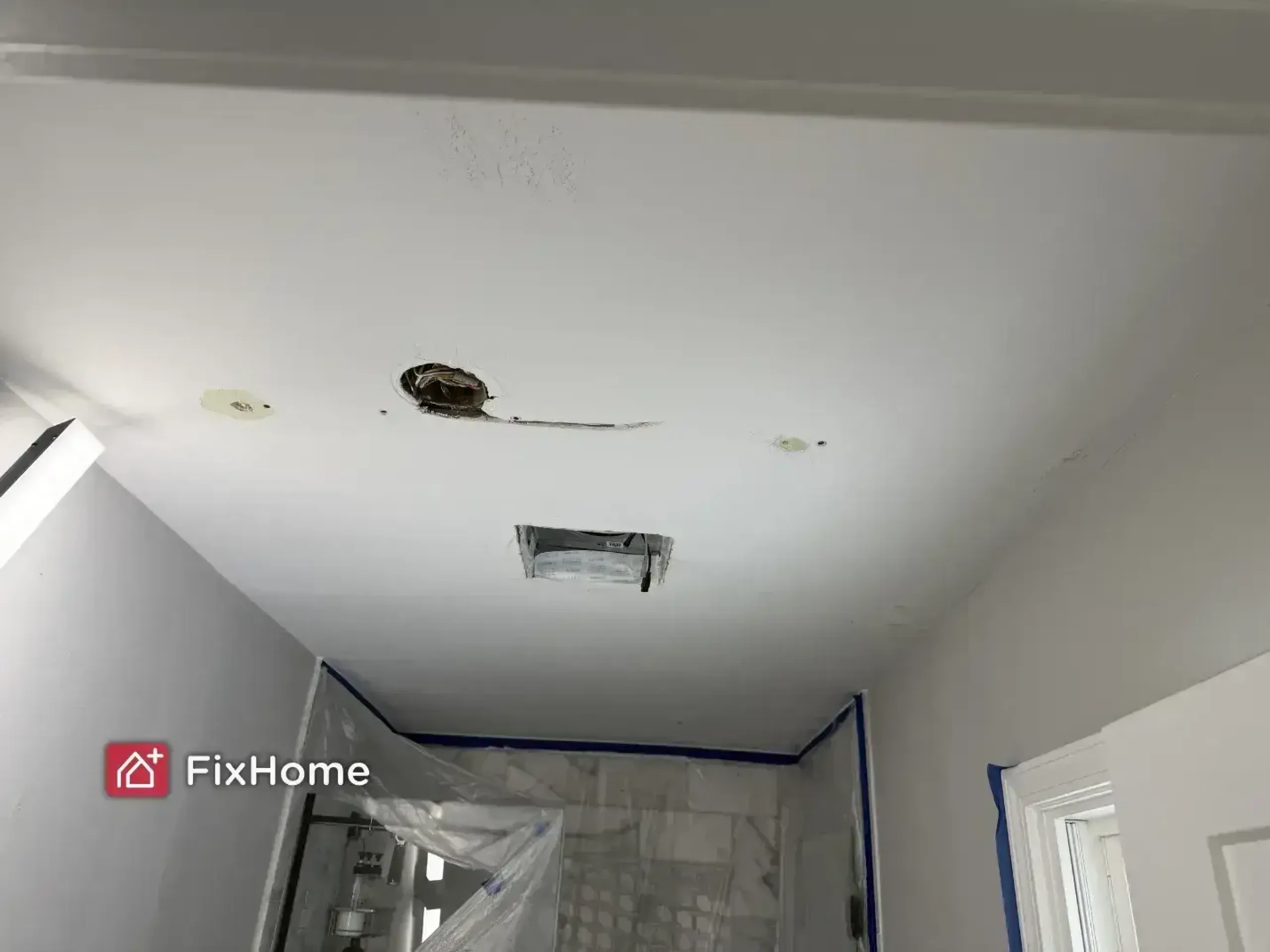 Ceiling with water damage, holes, and a light fixture opening in a Deerfield home bathroom before painting