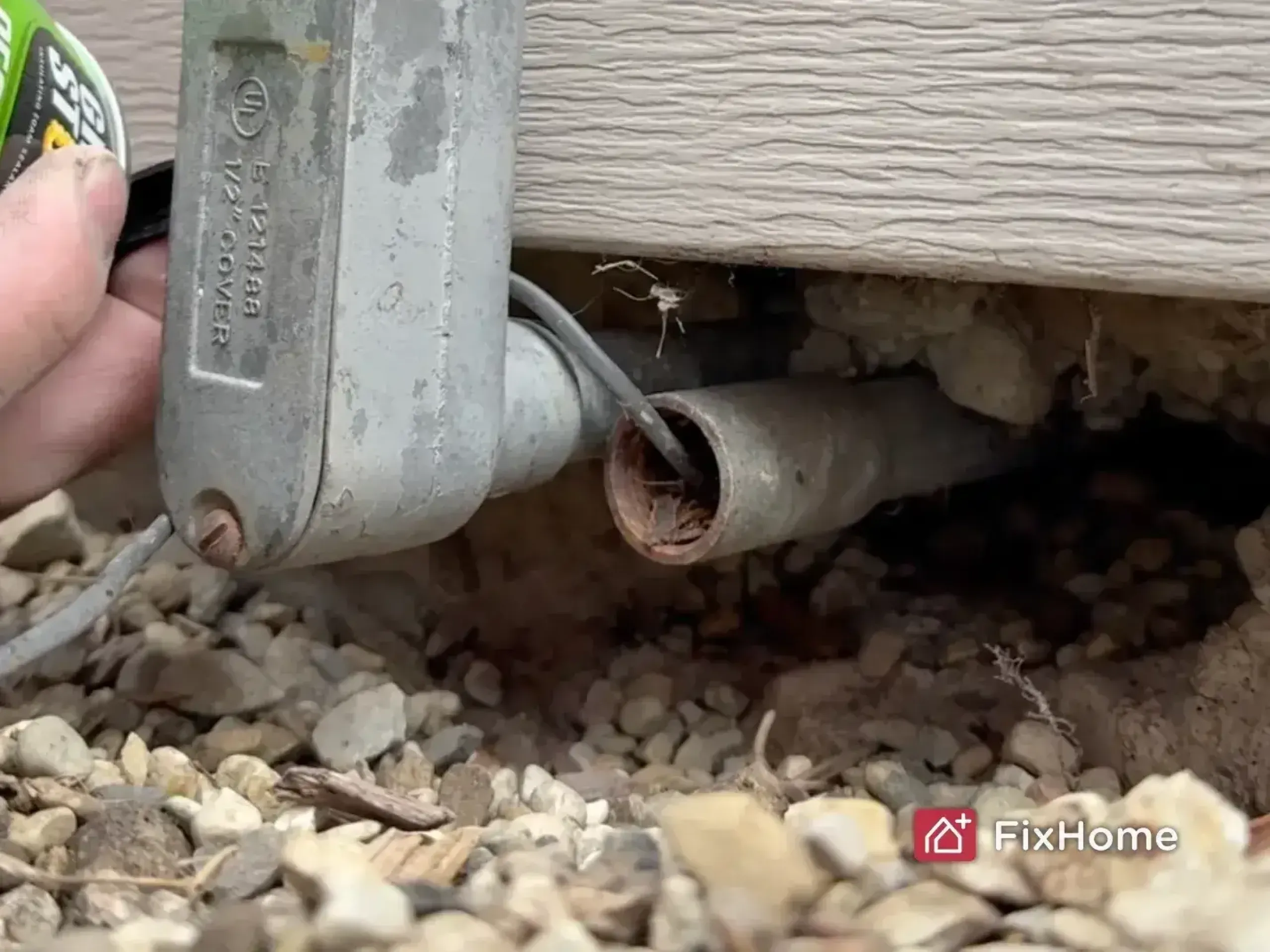 Close-up of pestblock foam filling an opening near a utility pipe.