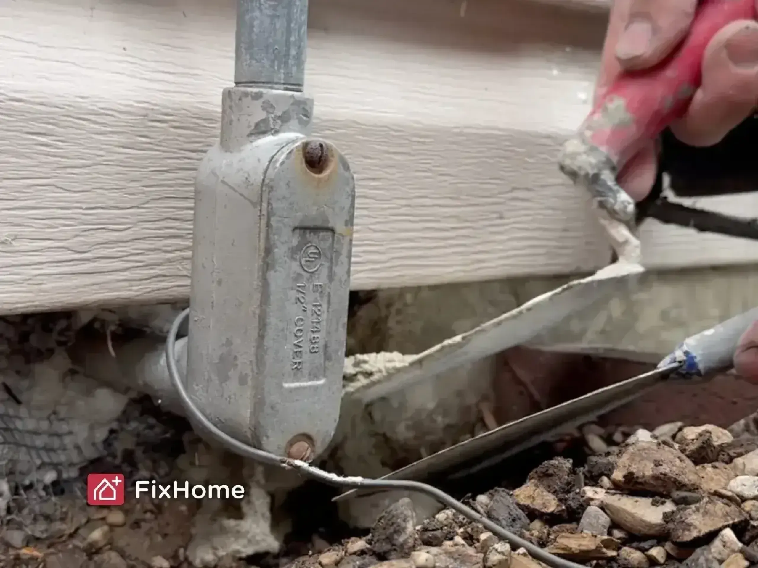 Close-up of gap filler being applied to a foundation crack for pest prevention
