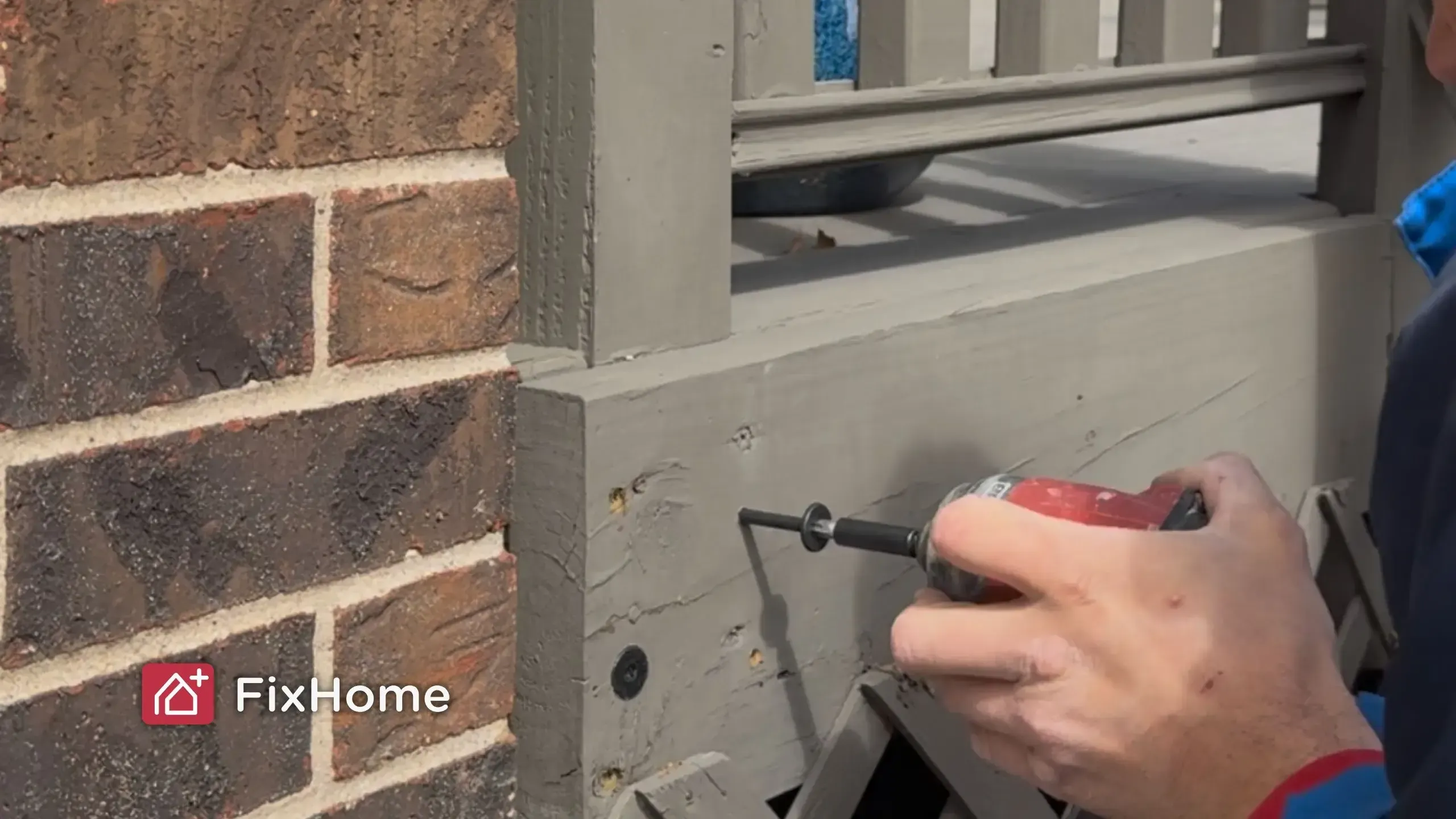 Handyman using power drill for repair deck wobbly railing post