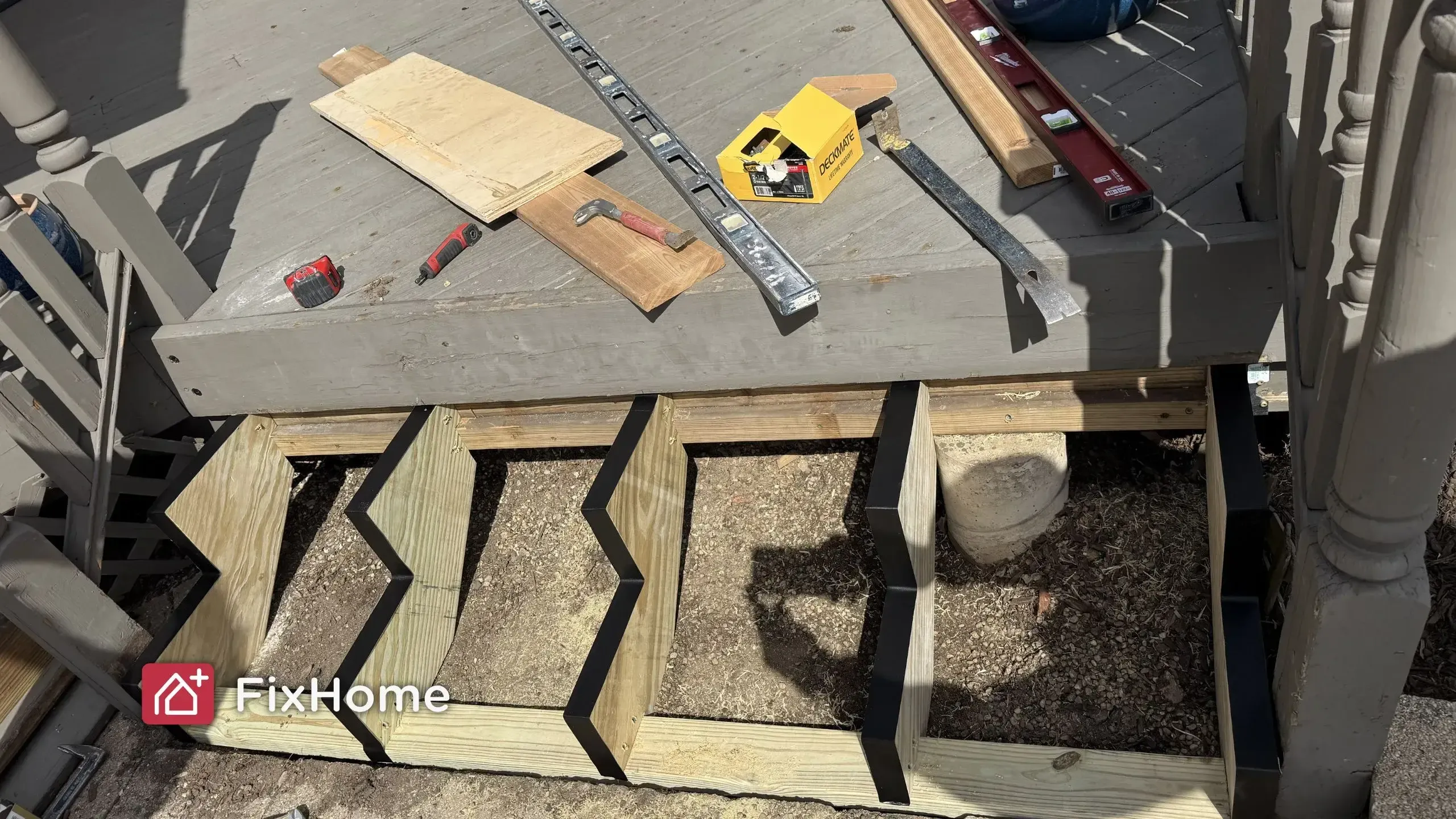 Deck repair tools and new stair stringers during deck rebuild in Chicago suburbs