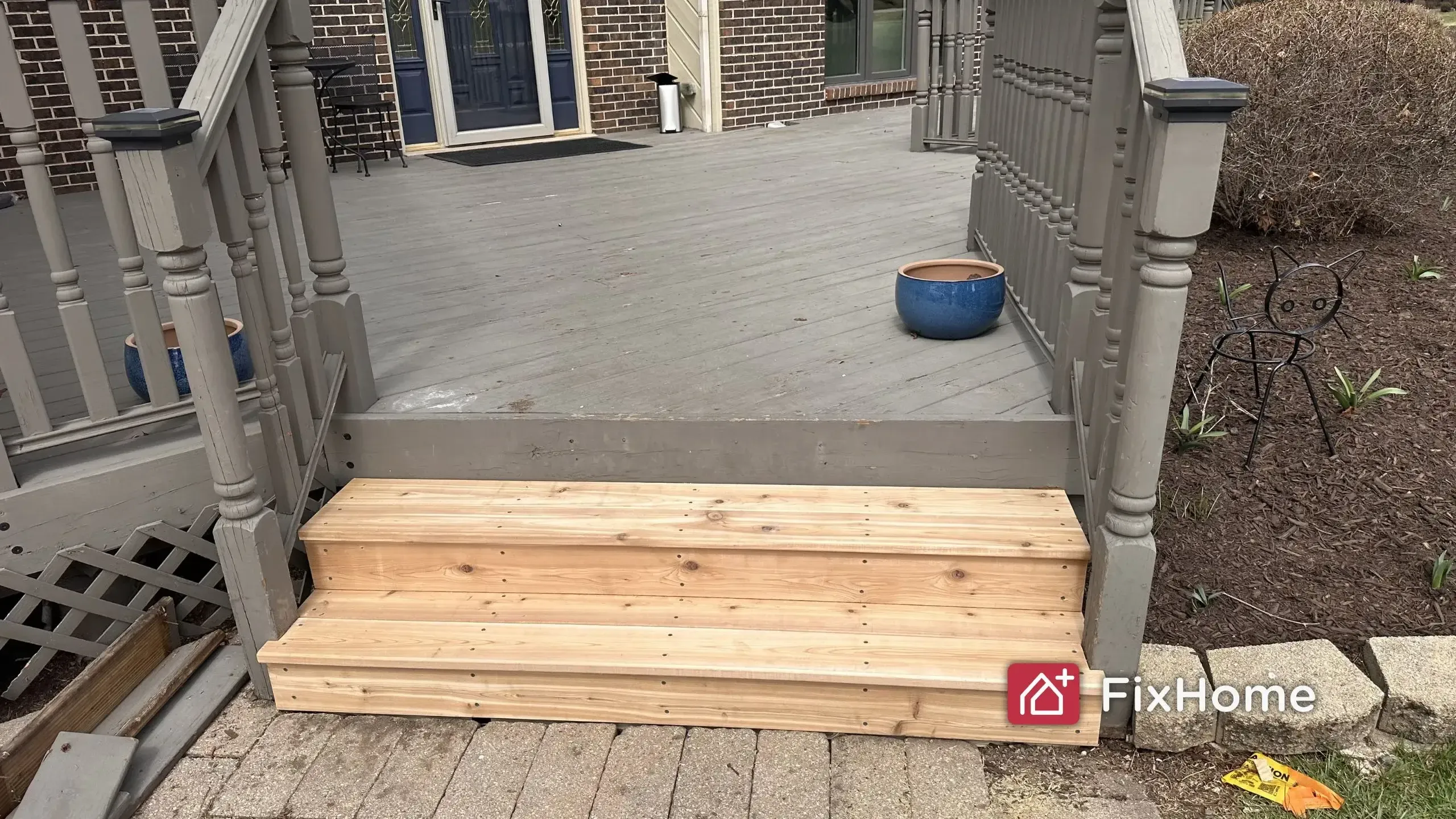 Deck repair with new wood stair steps and painted grey deck surface in NW Chicago suburbs