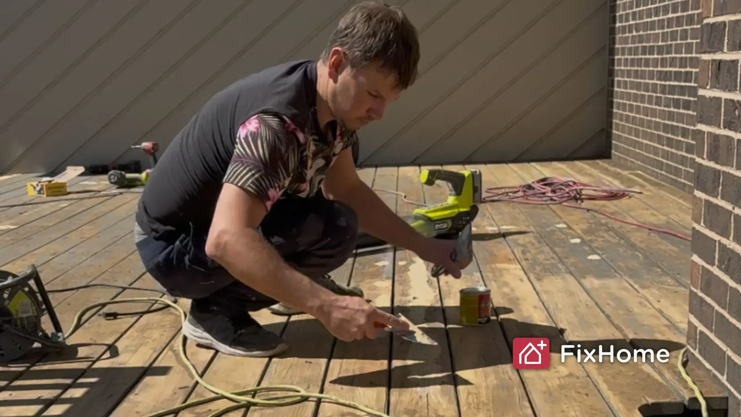 FixHome+ handyman A Fix Home+ craftsman uses putty to cover cracks in old board during a deck repair
