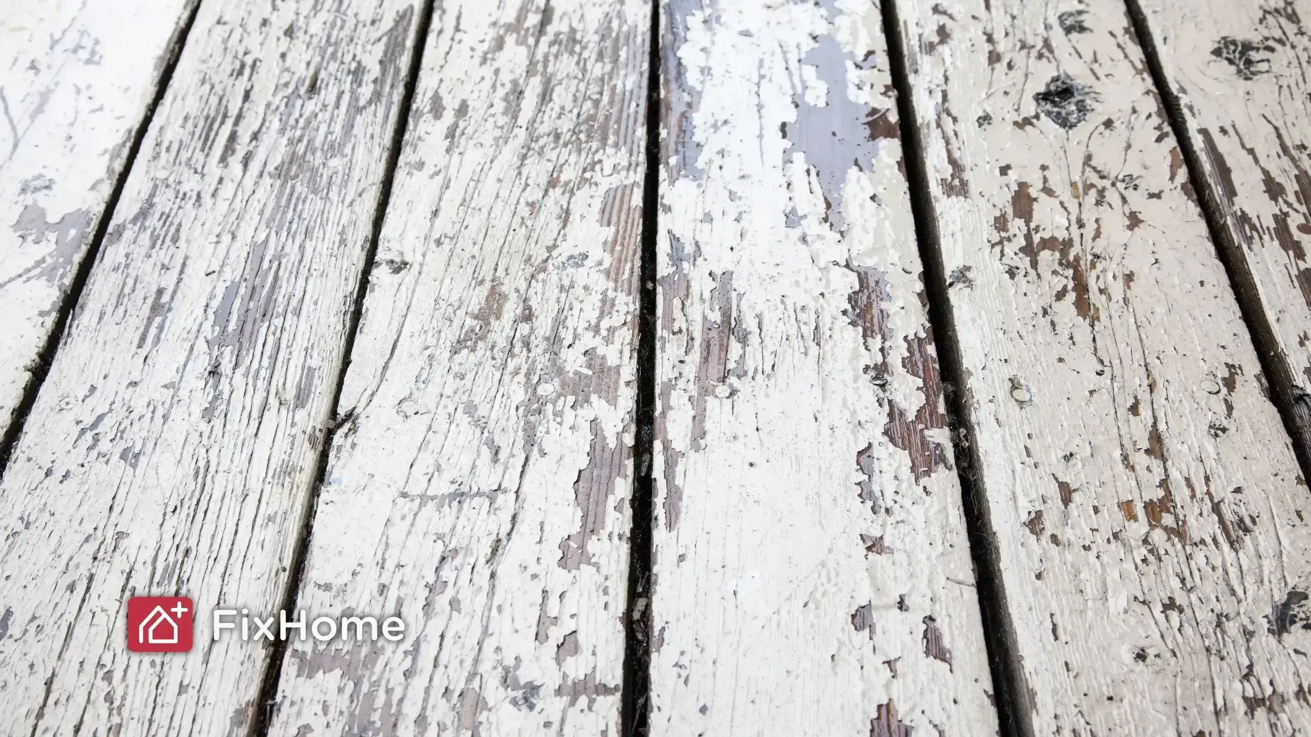 Peeling paint on a weathered wood deck