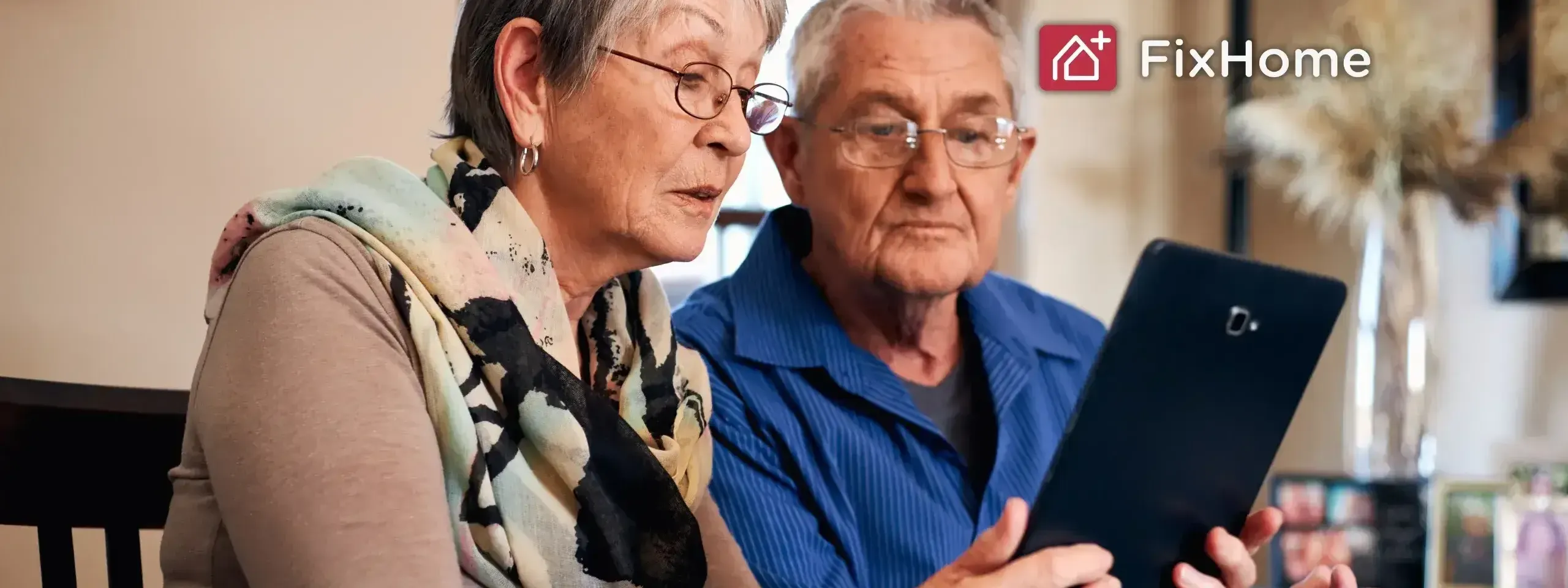 A couple looking at a tablet computer