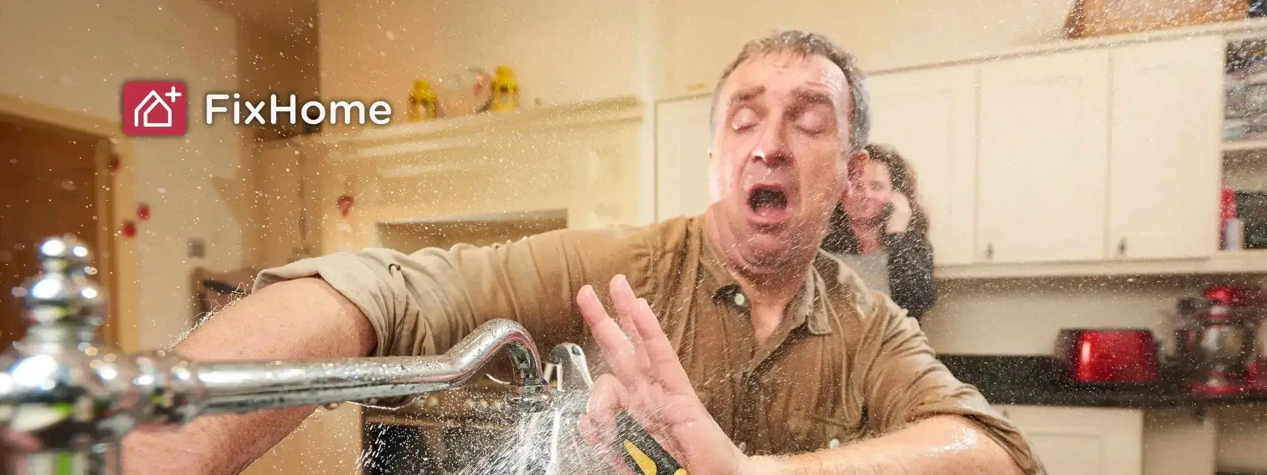 Person fixing a faucet with water spraying out, holding a wrench, in a kitchen