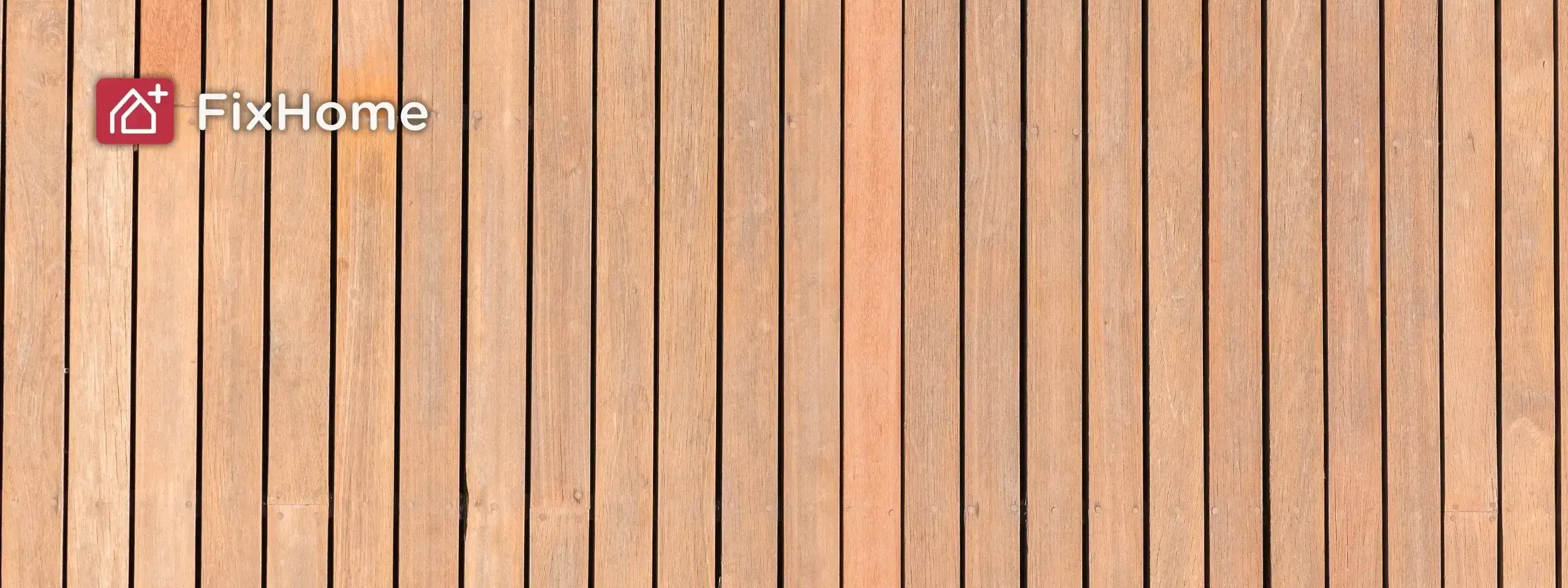 Wooden deck planks arranged in vertical lines, showing a light brown color 