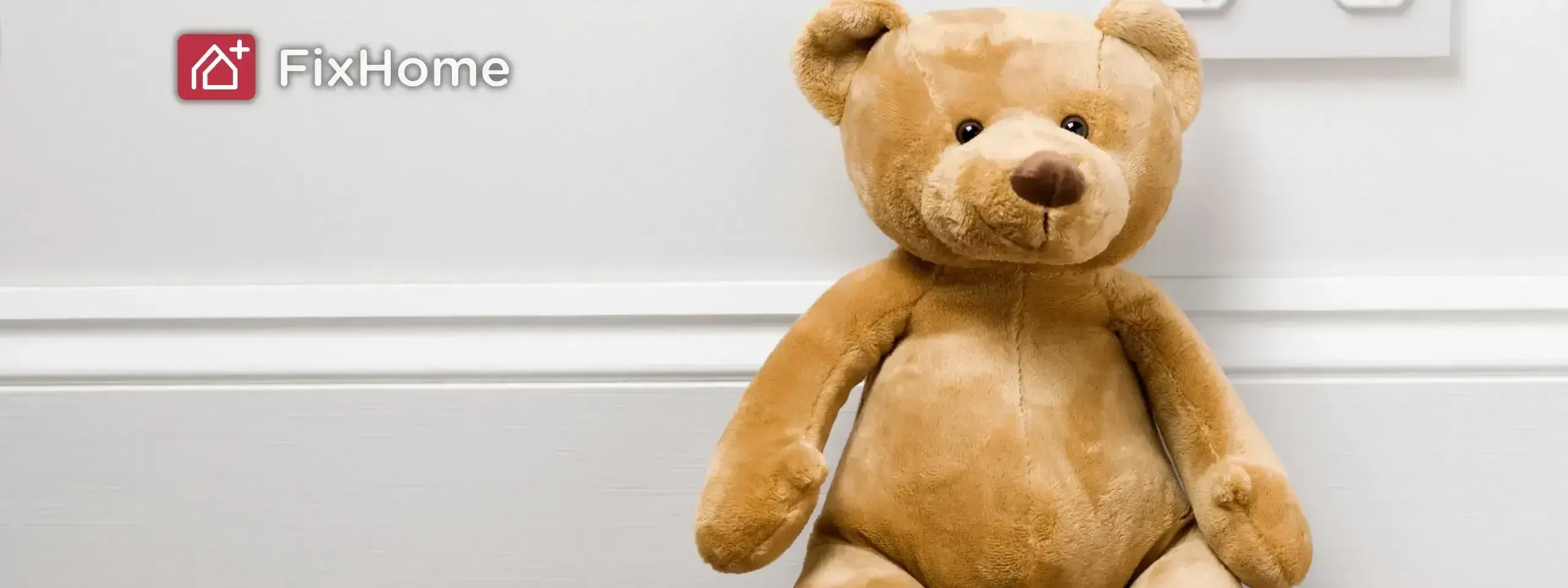 Teddy bear next to a outlet with closed protective covers