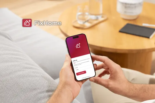 Man with phone using FixHomePlus App 