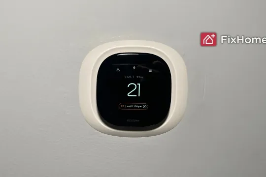 Smart thermostat installing on the white wall