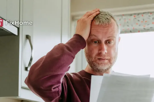 Man with electric bill in the kitchen