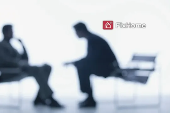 Silhouettes of two people in conversation