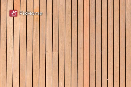Wooden deck planks arranged in vertical lines, showing a light brown color 