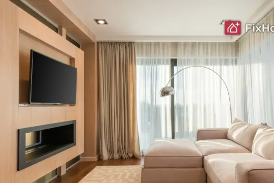 Modern living room with wall-mounted TV in a wooden media unit