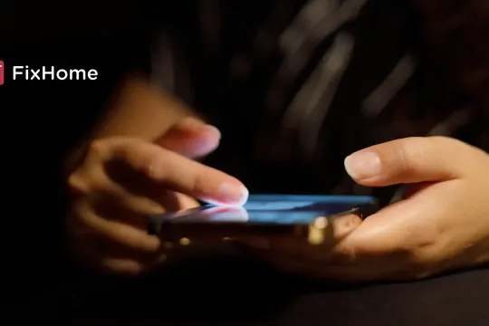 Female hand with phone in the dark space