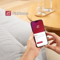 Man with phone using FixHomePlus App 